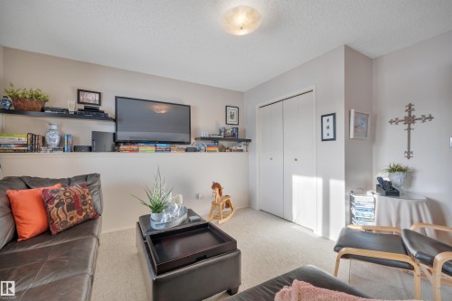 Living area with carpet and a textured ceiling - A49375 Rr 243, Rural Leduc County, AB 