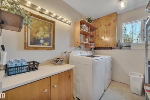 Laundry area with light floors, washer and dryer, and cabinet space - A49375 Rr 243, Rural Leduc County, AB 