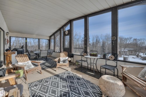 Sunroom / solarium with outdoor dining area, lofted ceiling, and wooden ceiling - A49375 Rr 243, Rural Leduc County, AB 