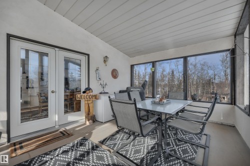 Sunroom / solarium with vaulted ceiling, outdoor dining area, and french doors - A49375 Rr 243, Rural Leduc County, AB 