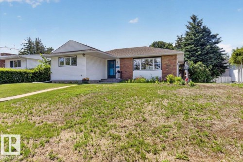 Ranch-style exterior featuring a combination of horizontal siding and brick facade - 10736 48 Street, Edmonton, AB 
