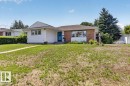 Ranch-style exterior featuring a combination of horizontal siding and brick facade - 10736 48 Street, Edmonton, AB 