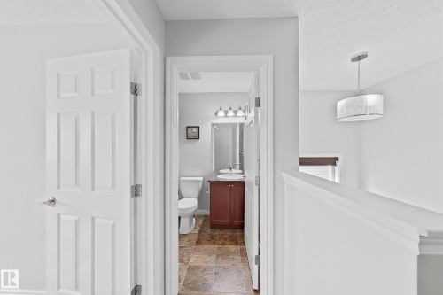 Bathroom featuring a dark wood-finish vanity, white countertop, and tiled flooring - 1806 28 Street Nw, Edmonton, AB 