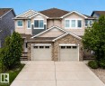 Duplex exterior featuring stone veneer and horizontal siding - 1806 28 Street Nw, Edmonton, AB 