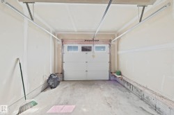 Interior garage space with a white paneled door featuring upper transom windows - 