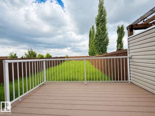 Spacious outdoor deck featuring composite decking and white metal railings - 1806 28 Street Nw, Edmonton, AB 