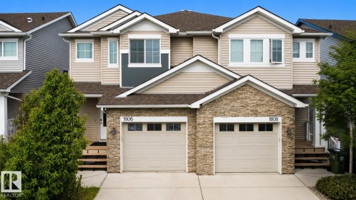 Duplex exterior with light-toned siding and stone veneer accents - 1806 28 Street Nw, Edmonton, AB 