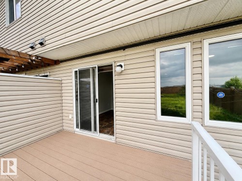Private deck featuring composite decking, vinyl siding, and white vinyl railing - 1806 28 Street Nw, Edmonton, AB 