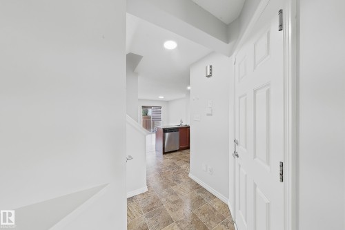 Entryway featuring a paneled white door, patterned tile flooring, and recessed lighting - 1806 28 Street Nw, Edmonton, AB 