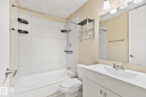 Bathroom featuring a white tiled shower and bathtub combination - 17059 98 Street, Edmonton, AB - Indoor Photo Showing Bathroom