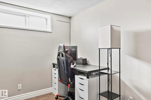 Recessed window offering natural light, smooth ceiling finish, light-toned wall paint, white baseboards, and wood-finish flooring - 17059 98 Street, Edmonton, AB - Indoor