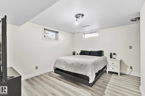Bedroom featuring light wood-finish flooring, recessed windows, and flush-mount ceiling lighting - 17059 98 Street, Edmonton, AB - Indoor Photo Showing Bedroom