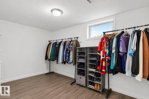 Bright room featuring wood-finish flooring, white walls, and a window providing natural light - 17059 98 Street, Edmonton, AB - Indoor With Storage
