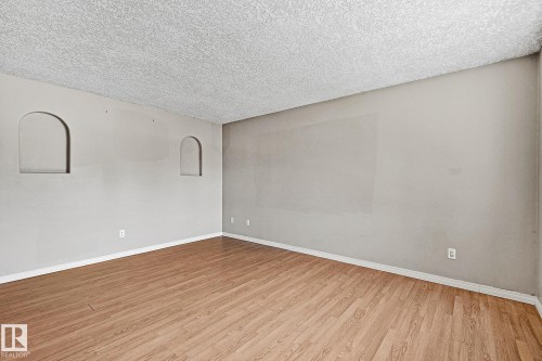 Spacious room with wood-finish flooring and neutral wall tones - 17059 98 Street, Edmonton, AB - Indoor Photo Showing Other Room