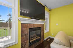 Fireplace featuring a tiled surround and white mantelpiece - 