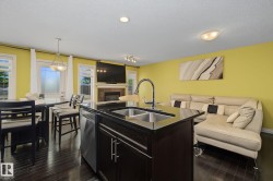 Kitchen island with a double basin sink, gooseneck faucet, and integrated dishwasher - 