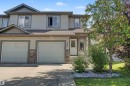 Two-story exterior featuring light gray siding with dark gray trim accents - 5205 168 Avenue, Edmonton, AB 