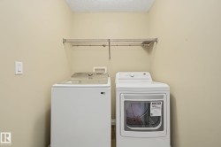 Dedicated laundry area featuring a wire shelving unit - 