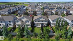Residential neighborhood featuring a series of two-story homes with pitched roofs - 
