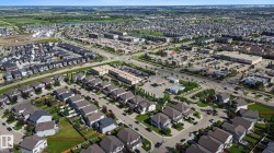 Aerial rendering of a residential development featuring single-family homes and townhomes - 