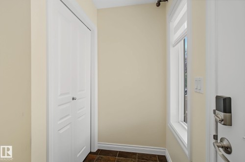 Entryway featuring light-toned walls, tile flooring, and a window with a roller shade - 5205 168 Avenue, Edmonton, AB 