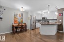 Modern kitchen featuring light cabinetry, stainless steel appliances, and dark countertops - 103 2203 44 Avenue, Edmonton, AB 