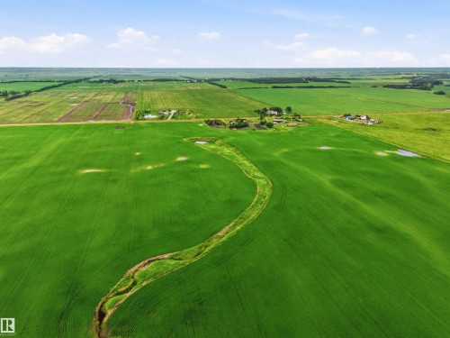Expansive green fields featuring a winding stream and several small bodies of water - 55111 Range Road 230, Rural Sturgeon County, AB 