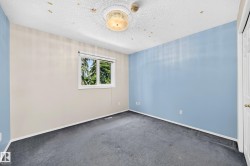 Interior room featuring wall-to-wall carpeting, a large window, and a flush-mount ceiling light fixture - 