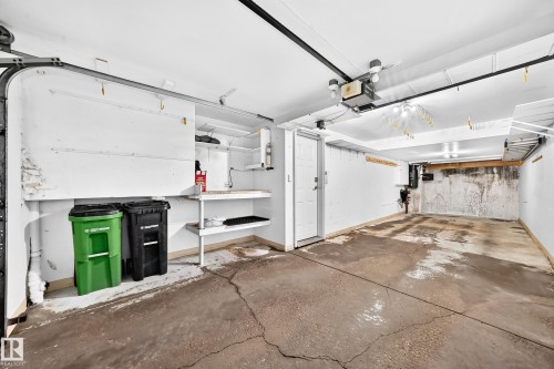Spacious two-car garage with a concrete floor and white painted walls - 51 9630 176 Street, Edmonton, AB 
