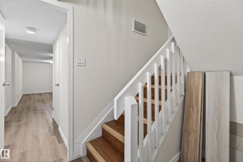 Staircase featuring wood-finish treads and white balusters - 156 Lee Ridge Road, Edmonton, AB - Indoor Photo Showing Other Room