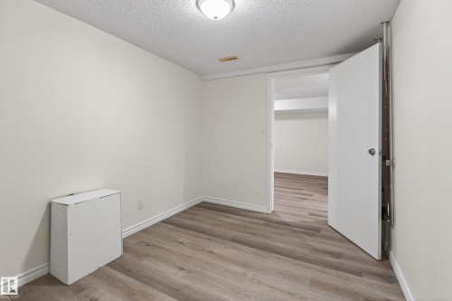 Room featuring light wood-finish flooring, white painted walls, white baseboards, and a white ceiling with a flush-mount light fixture - 156 Lee Ridge Road, Edmonton, AB - Indoor Photo Showing Other Room