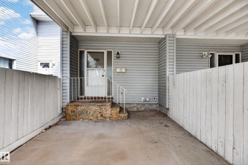 Covered entry with concrete flooring and light gray siding - 156 Lee Ridge Road, Edmonton, AB - Outdoor With Exterior