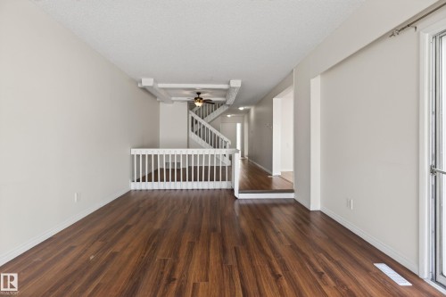 Spacious room featuring wood-finish flooring, white baseboards, and a neutral wall palette - 156 Lee Ridge Road, Edmonton, AB - Indoor Photo Showing Other Room