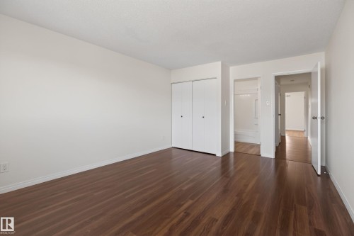 Spacious room featuring wood-finish flooring, white walls, and a ceiling with a textured finish - 156 Lee Ridge Road, Edmonton, AB - Indoor Photo Showing Other Room