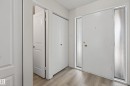 Entryway featuring a white main door with two fluted glass sidelights, complemented by wood-finish flooring - 156 Lee Ridge Road, Edmonton, AB  - Indoor Photo Showing Other Room 