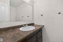 Bathroom vanity featuring a brown countertop, white oval sink, and chrome faucet - 156 Lee Ridge Road, Edmonton, AB  - Indoor Photo Showing Bathroom 