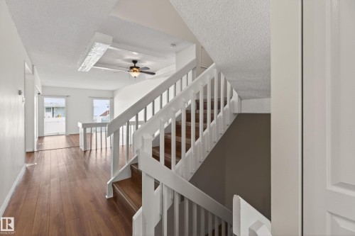 White baluster staircase with wood-finish treads - 156 Lee Ridge Road, Edmonton, AB - Indoor Photo Showing Other Room
