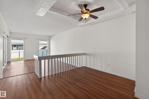Spacious room featuring wood-finish flooring, white walls, and a ceiling fan with light fixture - 156 Lee Ridge Road, Edmonton, AB - Indoor Photo Showing Other Room