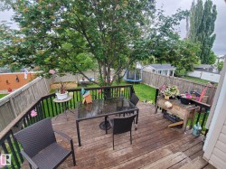 Wood-finish deck with black metal railings - 