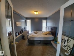 Carpeted room with blue-painted walls and white trim - 