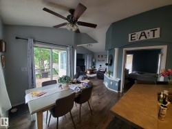 Dining area featuring wood-finish flooring and direct access to an outdoor deck through sliding glass doors - 