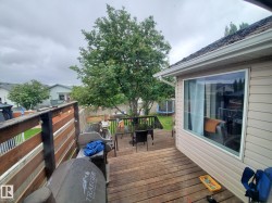 Expansive outdoor deck featuring wood flooring and a privacy fence - 