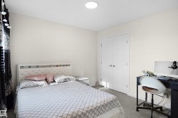Bedroom featuring light-toned walls, recessed lighting, and grey carpet flooring - 