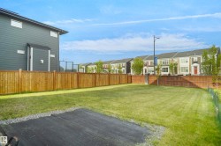 Expansive grass yard with a wood privacy fence - 
