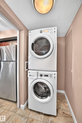 Dedicated laundry area with stacked white appliances - 308 18126 77 Street, Edmonton, AB 