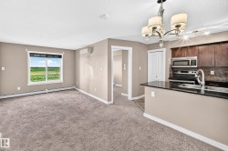 Open-concept living space featuring a window with expansive outdoor scenery, a split-system air conditioning unit, and plush carpet flooring - 