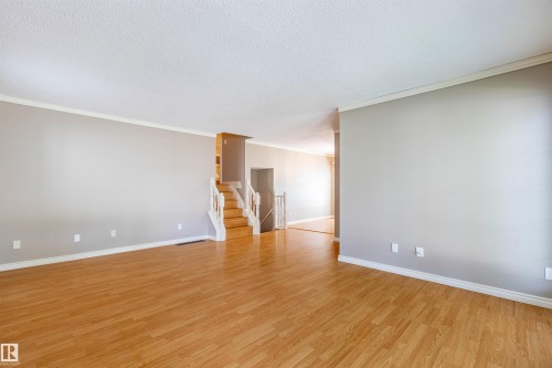 Spacious interior featuring wood-finish flooring and light gray walls - 3 Glenforest Crescent, Stony Plain, AB 