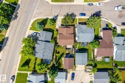 Aerial perspective showcasing a residential lot with a gabled-roof home - 