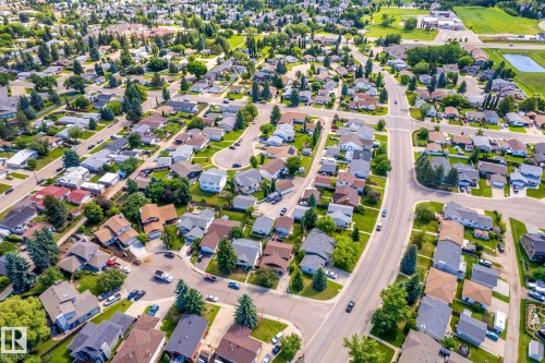 Aerial perspective of a residential neighborhood featuring numerous detached homes with varying rooflines and mature tree coverage - 3 Glenforest Crescent, Stony Plain, AB 