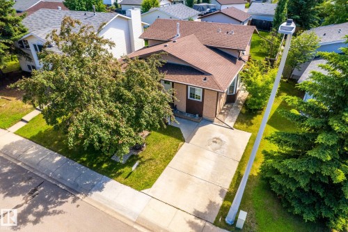 Single-story property featuring a brown shingle roof, light brown siding, and white trim windows - 3 Glenforest Crescent, Stony Plain, AB 